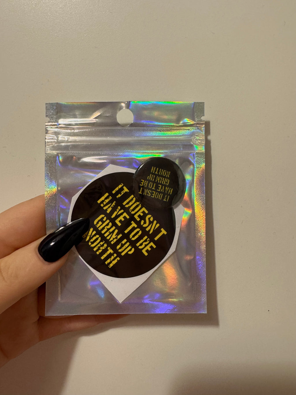 'it doesn't have to be grim up north' badge & sticker pack