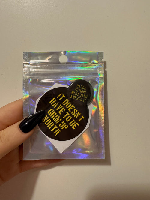 'it doesn't have to be grim up north' badge & sticker pack